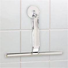 a close up of a metal handle on a white tiled bathroom wall with tile flooring