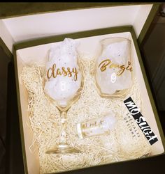 two wine glasses in a box with the word classy bride and groom written on them