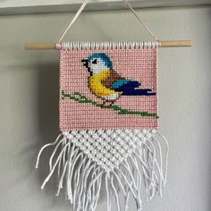 a colorful bird is hanging on a wall