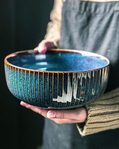 a person holding a bowl in their hands