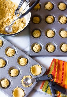 a muffin tin filled with cupcake batter next to a bowl of peanut butter