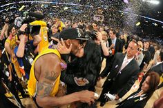 a man and woman kissing while confetti is thrown in the air