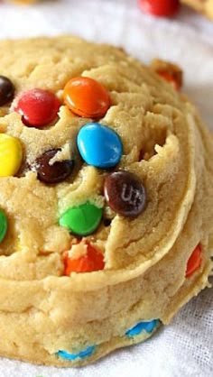 a close up of a cookie with m & m cookies on the top and candy in the middle