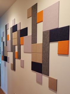 the wall is decorated with different colored squares and rectangles