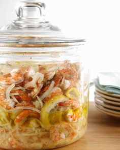 a glass jar filled with food sitting on top of a wooden table