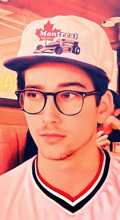 a young man wearing glasses and a hat