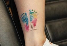 a woman's foot with colorful ink painted on her left leg and the word love written in it