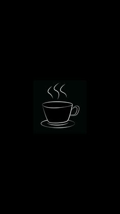 a coffee cup with steam rising out of it on a saucer in the dark