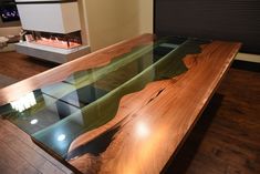 a wooden table with glass top in front of a fireplace