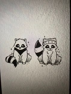 two raccoons are sitting next to each other on a white paper sheet with black ink