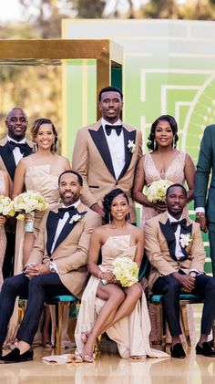 a group of people in formal wear posing for a photo