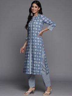 This is a beautiful 2-piece set. The set comes with straight cut kurta consist of ethnic motif print detailing has mandarin collar, 3/4th sleeves, calf length & side slits teamed with printed trouser pants has elasticated waistband and slip on closure. Piece-2 Piece Set Color-Blue Kurta Fabric-Cotton Bottom Fabric-Cotton Work - Ethnic Motif Print Detailing Neck-Mandarin Collar Sleeves- 3/4th Sleeves Kurta Length - Calf Length Bottom-Elasticated Waistband & Slip-on Closure Style-Kurta Trouser Set Navratri Sets With Printed Border And Straight Kurta, Spring Block Print Straight Kurta Set, Fitted Pant Set With Straight Kurta And Printed Motifs, Fitted Pant Set With Printed Motifs And Straight Kurta, Spring Straight Kurta With Printed Border, Fitted Block Print Straight Kurta Set, Eid Ikat Print Straight Kurta, Ikat Print Straight Kurta Set For Diwali, Diwali Ikat Print Straight Kurta Set