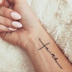 a woman's wrist with a tattoo on it that says love and is written in cursive writing