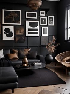 a living room with black walls and pictures on the wall