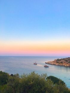 the ocean is full of boats on it's way to the shore at sunset