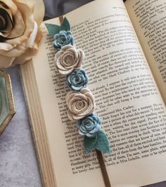 an open book with some flowers on it