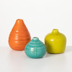 Measuring 3", 4" and 5" tall, this trio of ceramic vases are the perfect way to add a burst of color. Curvy and vibrant, each has an opening perfect for a favorite stem. Over the last 55 years, Sullivans has become an industry leader in home decorations. Our brand is rooted in tradition while incorporating modernized trends to keep your home looking up to date with timeless style. Here at Sullivans, we pride ourselves on creating product designs focused on quality and value, ensuring that our cu Bookshelf Mantle, Décor Table, Farmhouse Vase, Boho Vase, Small Vases, Rustic Vase, Beautiful Centerpieces, Faux Florals, Ceramic Vases