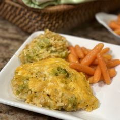 a white plate topped with food next to carrots and broccoli