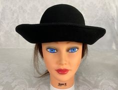 "Here we have a vintage mid-century Woman's black Bucket Hat. This has a wide rolled brim that measures 3\" and a pretty velvet bow on the back. The circumference is 21\". This could use a good brushing. I try my best to give accurate descriptions, although I am no expert, plus I'm human and sometimes I might miss a flaw. I always provide high resolution photos and consider them to be part of the description. I encourage you to zoom in and examine them closely as they show exactly what you will Retro Black Hat With Short Brim, Black Brimmed Retro Hat, Black Retro Brimmed Hat, Black Wide Brim Retro Hat, Vintage Black Brimmed Hat, Vintage Black Wide Brim Hat, Black Wide Brim Vintage Hat, Vintage Black Adjustable Hat, Black Adjustable Vintage Hat