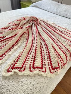 a crocheted blanket sitting on top of a bed