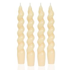 three candles are lined up in the shape of long, spirals on a white background