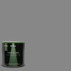 a can of behrorma's marquee green paint on a dark green background