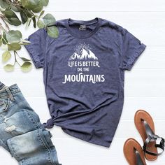 Mountains Shirt, Life is Better on the Mountain, Camping Tee Shirt, Outdoor Shirt, Hiking Shirt, Adventure Shirt, Nature Shirt HI! Welcome to my store, I'm delighted to see you here. My store's main goal is to provide you with premium everyday apparel with the best graphic t-shirts. I see you as a friend, not just a customer. I'm sure you'll love my designs. You can order the same design 4XL and 5XL large sizes from the link, please specify the details in the order note.   https://etsy.me/3Cfke0 Outdoor Short Sleeve Slogan Tops, Outdoor Cotton T-shirt With Funny Print, Funny Print Short Sleeve Tops, Cotton T-shirt With Funny Print For Outdoor, Outdoor Cotton Shirt With Letter Print, Outdoor Cotton Tops With Letter Print, Casual Outdoor T-shirt With Funny Text, Camping Tee Shirts, Mountains Shirt