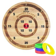 a wooden target with numbers and rings on the side, in front of three rubber rings