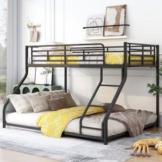 a black metal bunk bed sitting on top of a wooden floor next to a window