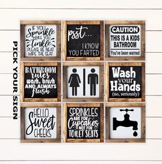 a set of six bathroom signs mounted to a wall