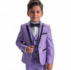 a young boy wearing a purple suit and bow tie