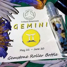 a bottle of gemstone roller bottle next to a sign with the name gemin on it