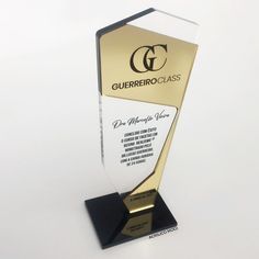 a gold and black glass award on a white surface with the words guerferro class