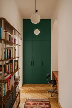 a room with bookshelves and a rug on the floor