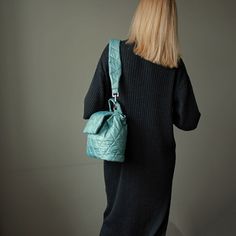 "Green mint bucket bag quilted with detachable strap. Handmade green nylon bucket shoulder bag for women. Height - 23 cm  ( 9,05 \" ) Width - 31 cm   ( 12,20 \" ) Depth - 9 cm ( 3,54 \" ) Strap  - 75 cm  ( 29,53 \" ) Green mint bucket bag made of quilted nylon fabric. Green shoulder bag has cotton lining, 1 pocket inside, detachable strap. The mint green bag fastens with 1 magnetic button. Green mini bag quilted for women. Mint mini shoulder bag quilted drawstring. Beautiful small handbag light green color. Designer green small handbag. Puffer green mint mini bag handmade. Quilted mini shoulder bag cute for woman. Mint green quilted bucket bag. Unique handmade green bucket drawstring bag. Cute mini bag green mint color." Green Quilted Shoulder Bag For Travel, Quilted Green Shoulder Bag For Travel, Green Quilted Crossbody Shoulder Bag, Everyday Green Quilted Bag, Trendy Green Quilted Shoulder Bag, Green Quilted Shoulder Bag, Green Quilted Tote Shoulder Bag, Mint Green Bag, Mint Green Bags