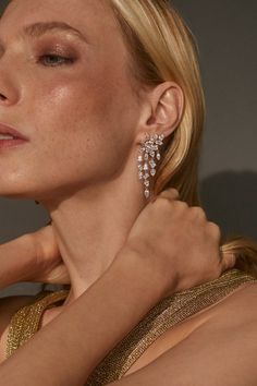 Add a touch of modern glamour to your outfit with these statement-making chandelier earrings featuring carefully placed mixed-cut CZ stones. Elevate your look with a sparkling touch of intricate detail.