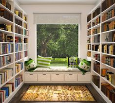 there are many bookshelves in the room and one has a window seat on it