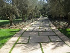 a stone walkway in the middle of a park