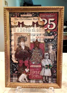 an old fashioned christmas card is displayed in a frame on a table with other items