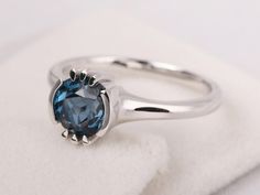 Modern Blue Topaz Birthstone Ring, Modern Round Cut Topaz Ring For Gift, Modern Round Cut Topaz Ring Gift, Modern Round Cut Topaz Ring As Gift, Solitaire Round Topaz Ring, Modern Round Topaz Birthstone Ring, Modern Topaz Birthstone Ring, Round Sapphire Ring With Tension Setting, Round Sapphire Ring With Tension Setting As A Gift