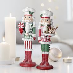 two christmas nutcrackers sitting next to each other on top of a table