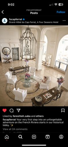 a living room filled with furniture and a chandelier