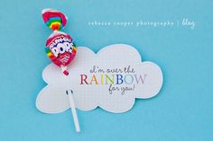 a candy lollipop on top of a white cloud with the words i'm over the rainbow for you