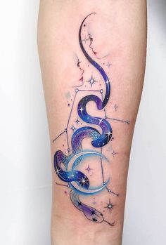 an artistic tattoo on the leg of a woman with stars and swirls in it