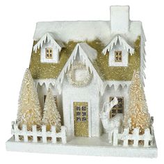 a white and gold christmas house with trees