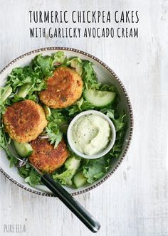 a salad with cucumbers, lettuce and ranch dressing in a bowl