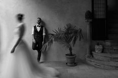 Wedding photography of Gabi & Enrico, in Tuscany, Florence 2022 / Photographer Alexandr Purcel / Destination wedding photographer  Wedding inspiration , Enrico stay at the wall in moment when bride is walking near Florence, Alexander, Portfolio, Photographer