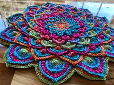 a crocheted doily on a wooden table