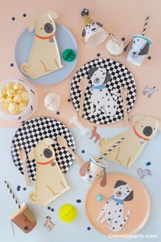 paper plates with dogs on them and cupcakes in the middle, along with other dog themed items