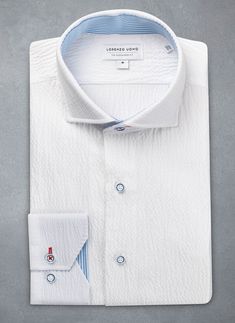 Crafted of the finest and softest seersucker, the Alexander in White Contrast Seersucker Shirt is at once easy and sophisticated. The red contrast stitching at the top button adds a dash of color to the pristine white. The gondolier stripe lends a meticulous, thought-out look to the garment, as do the custom blue-rimmed buttons. The Alexander is the trimmest of all our fits, calibrated to accentuate a lean, athletic body type. • Trimmest Fit • 99% Cotton 1% Spandex • Spread Collar • Imported • I Athletic Body Type, Seersucker Shirt, Athletic Body, Contrast Stitch, Sports Shirts, Neck Shirt, Workout Shirts, Alexander, Stitching